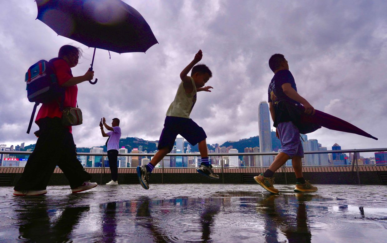 Hong Kong finds respite from historic heatwave as tropical rains sweep in